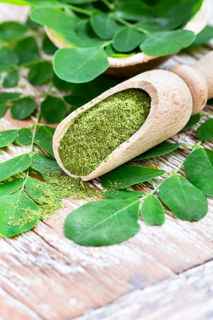 moringa-powder-wooden-scoop-with-original-fresh-moringa-leaves-wooden-table-close-up_100801-121